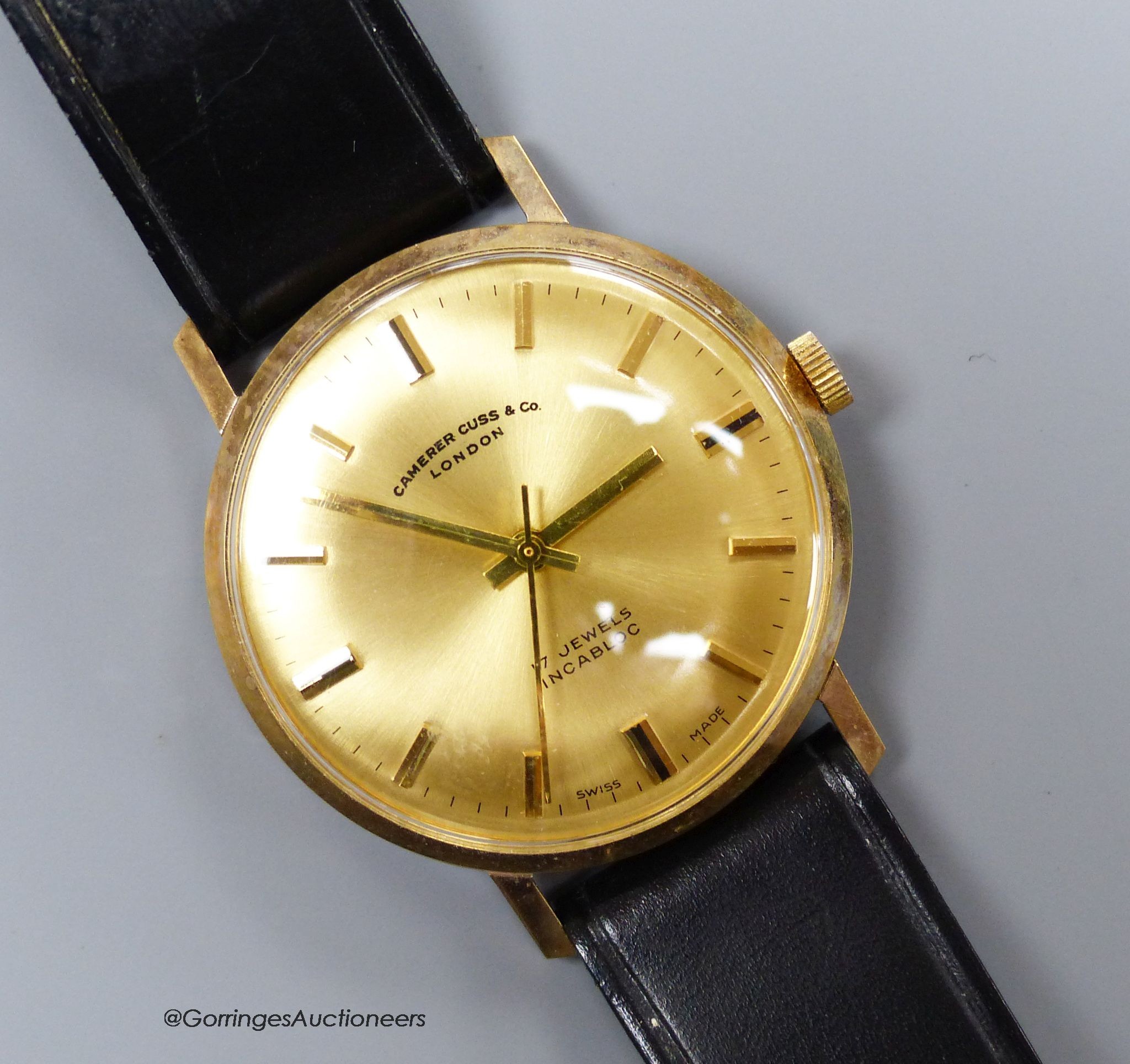 A gentleman's 9ct gold-cased wristwatch retailed by Camerer Cuss & Co, on leather strap, boxed